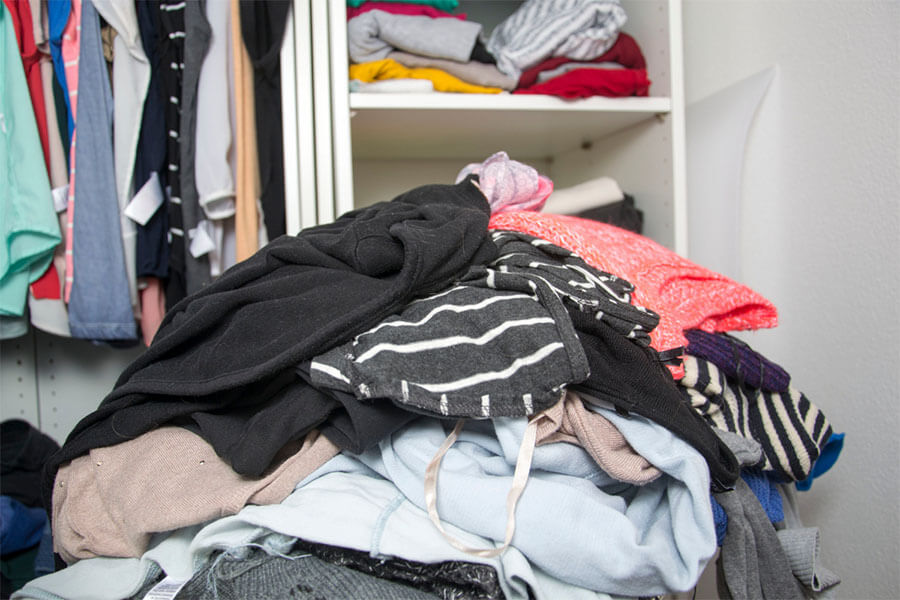 Pile of clothes piled up on the floor of a room
